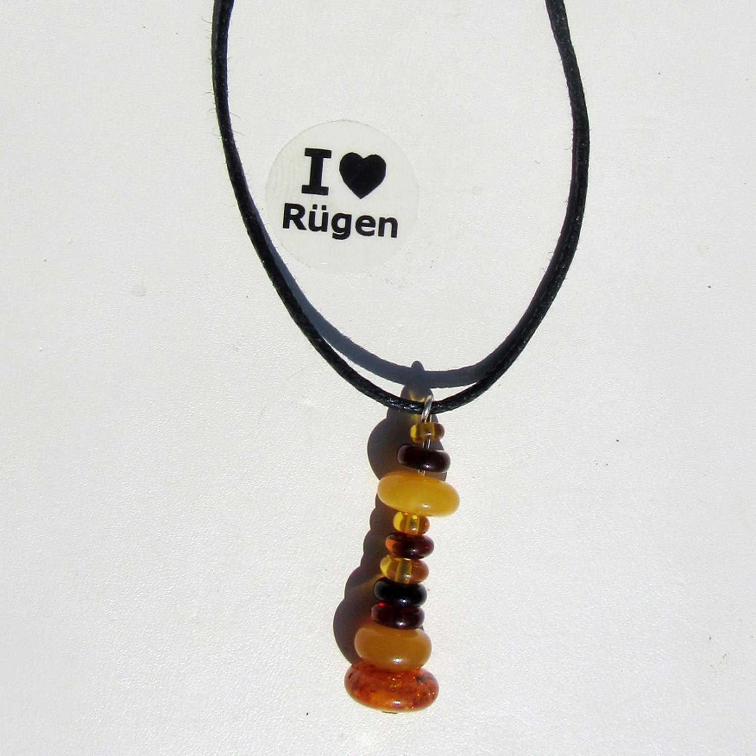 Bernsteinleuchtturm am Baumwollband, handgefertigt