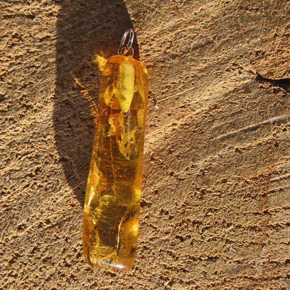 Länglicher Bernstein-Anhänger mit Inklusen von Rügen