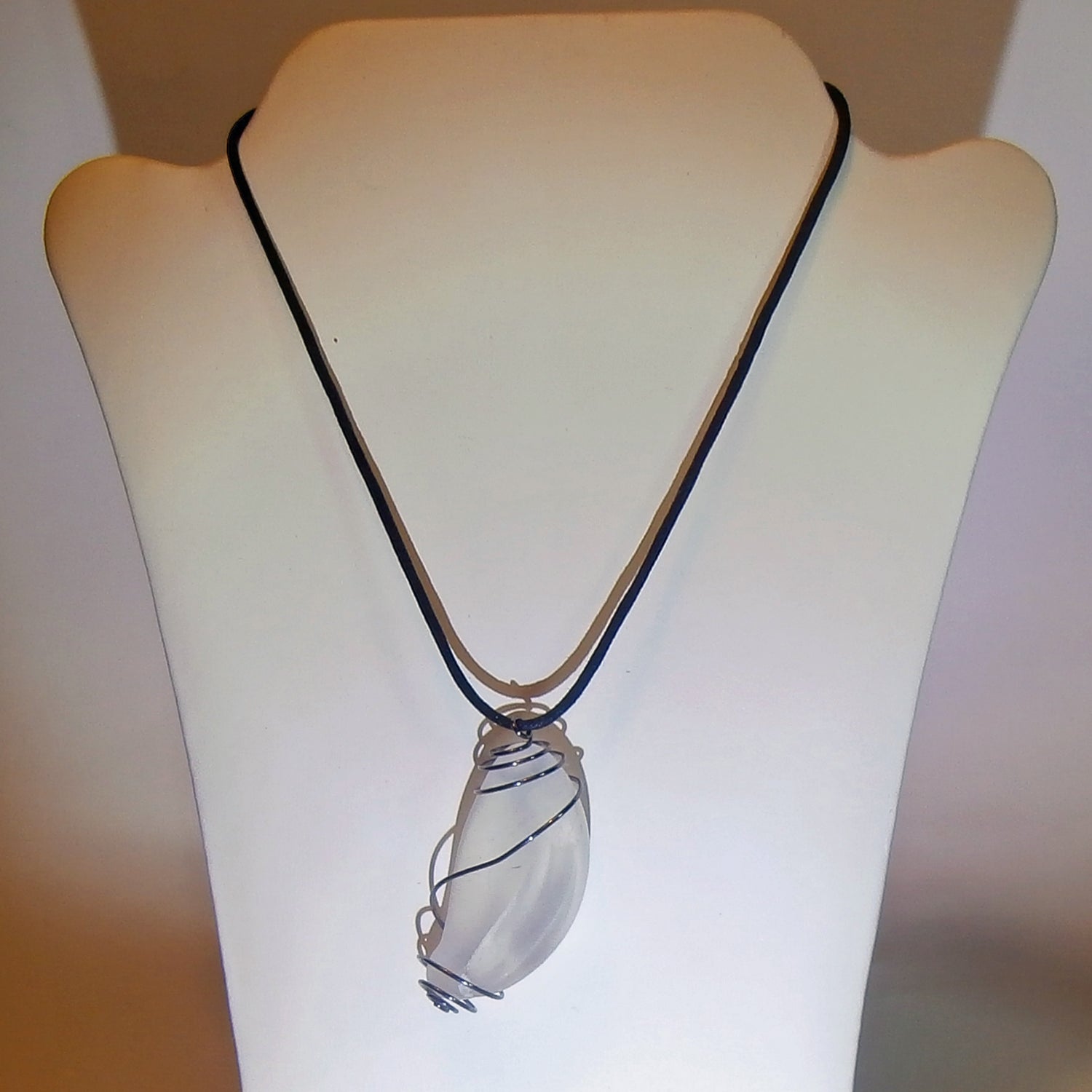 Anhänger aus weissem, transparenten Seeglas in einer platinfarbenen Spirale