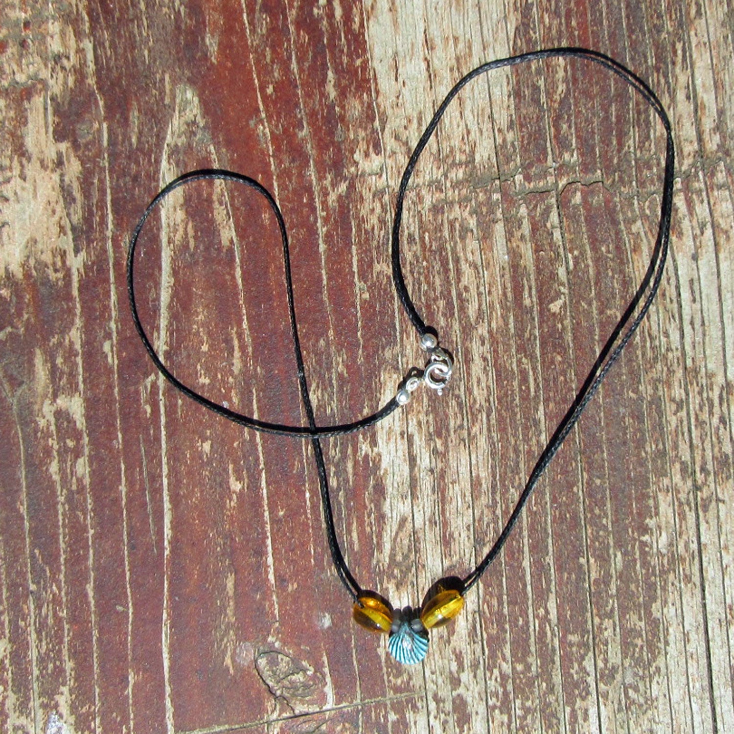 Grüne Muschel aus Kupfer mit Bernstein am Baumwollcollier