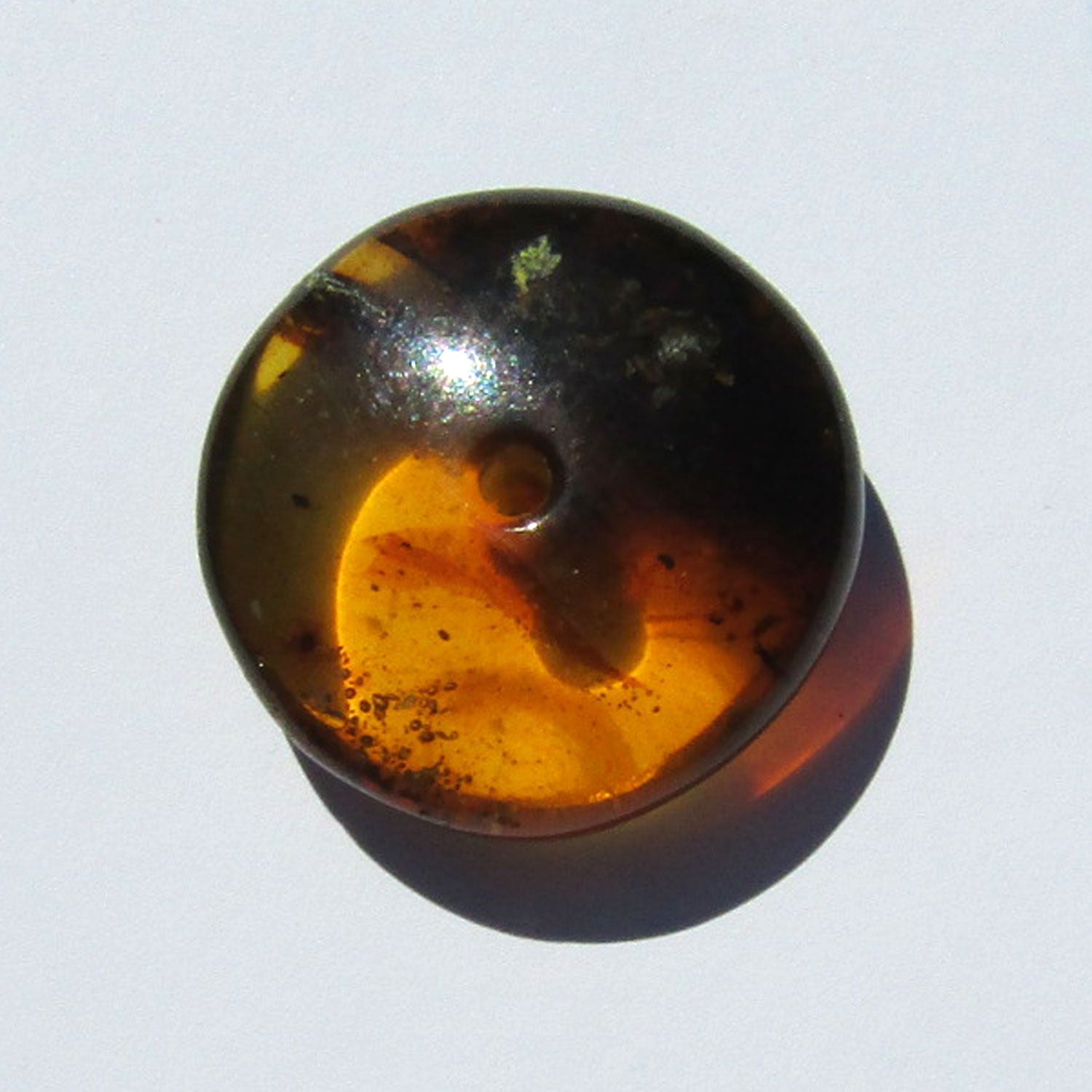 Bernsteindonut von Rügen mit dunklen Einschlüssen