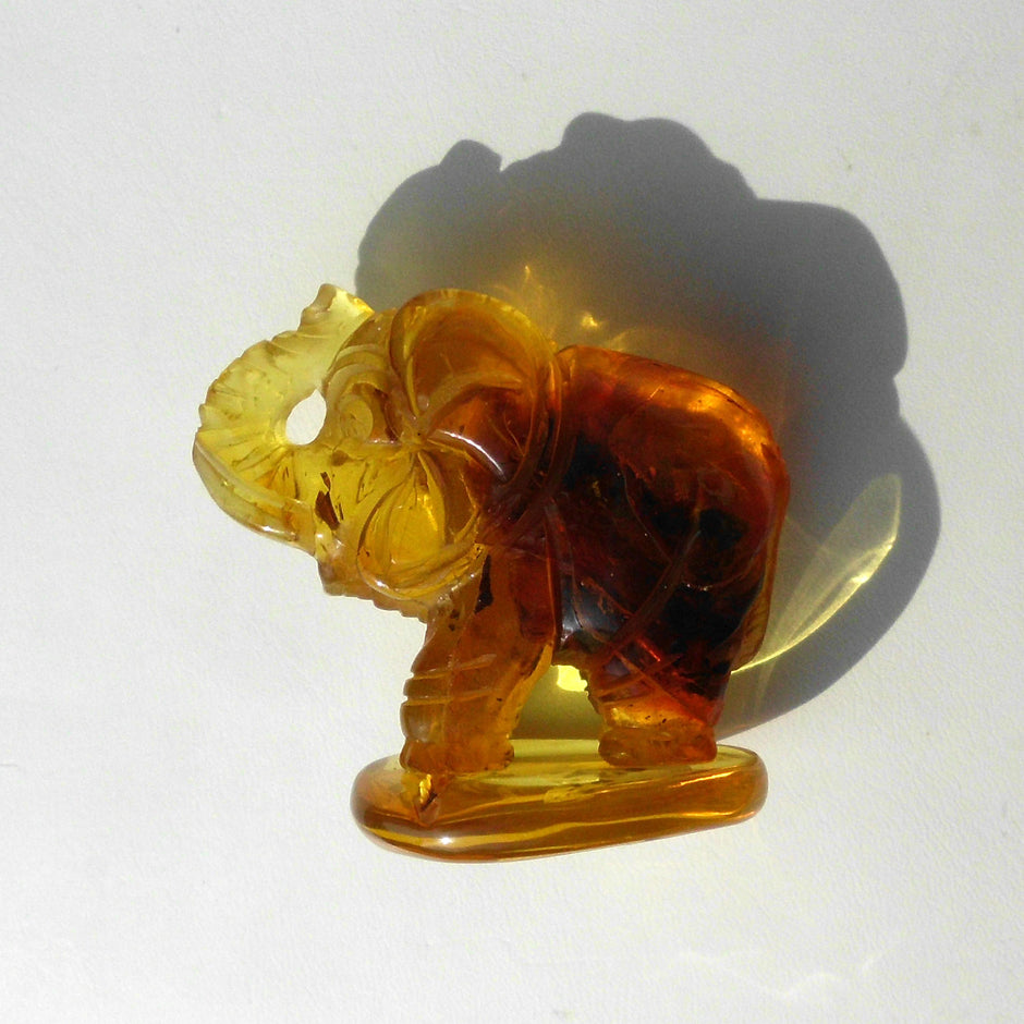 Grosser Elefant aus honigfarbigen Bernstein auf einem Bernsteinsockel