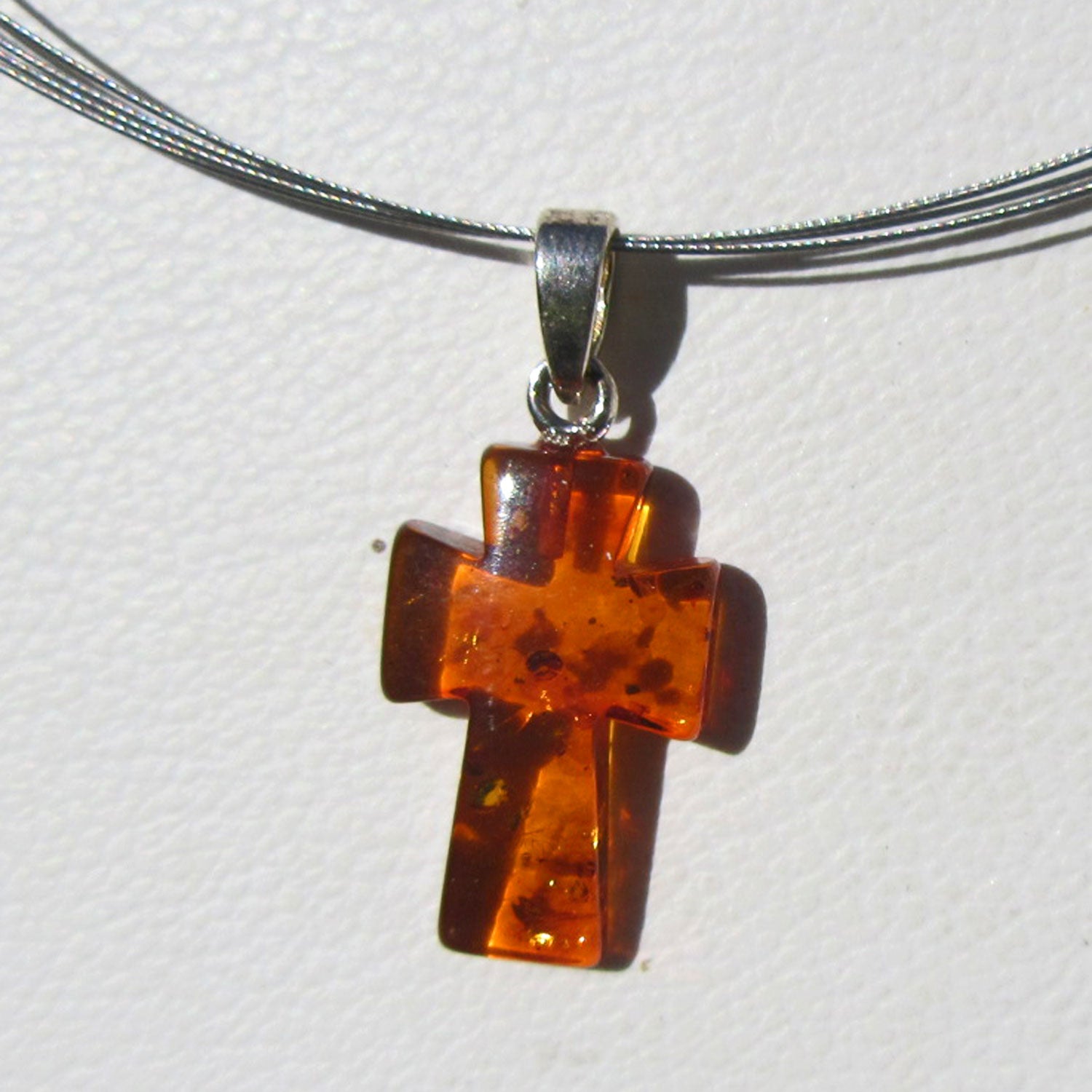 Einzigartiges Kreuz aus Bernstein mit Silberöse