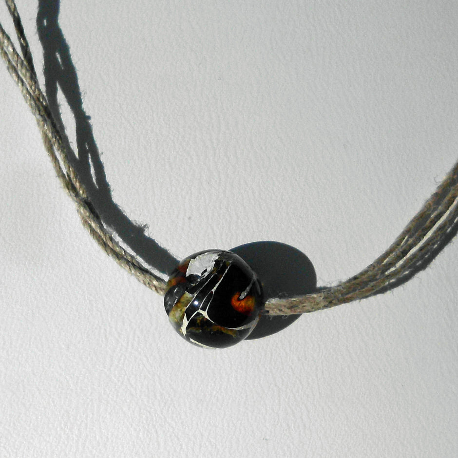 Einzelstück: Kleine Mosaikbernsteinperle auf Hanfcollier