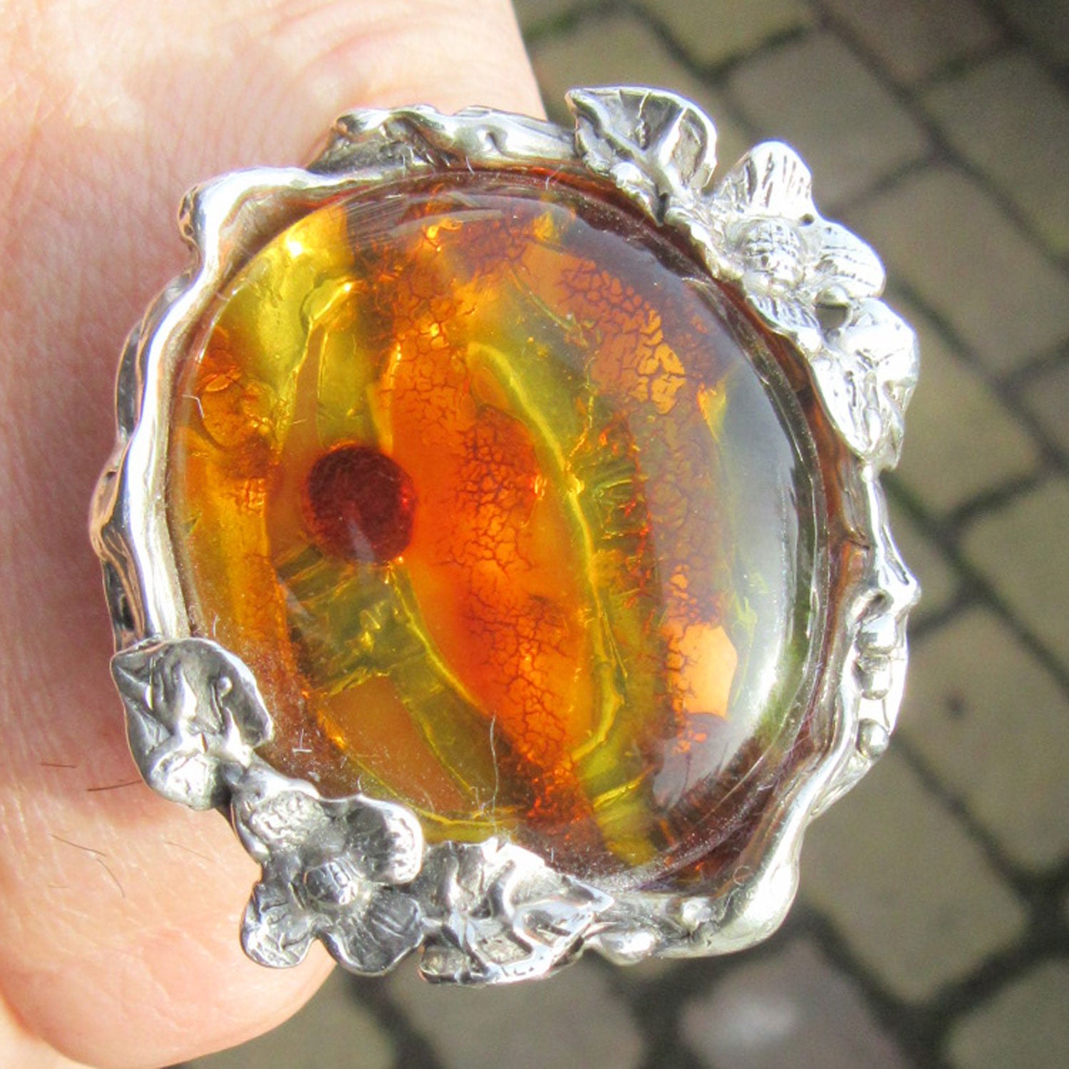 Mit Blumen und Blättern verzierter Fingerring aus Silber und schönem, goldgelben Bernstein