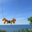 Bernsteine mit Kupferperlen und Schnecke am Drahtcollier