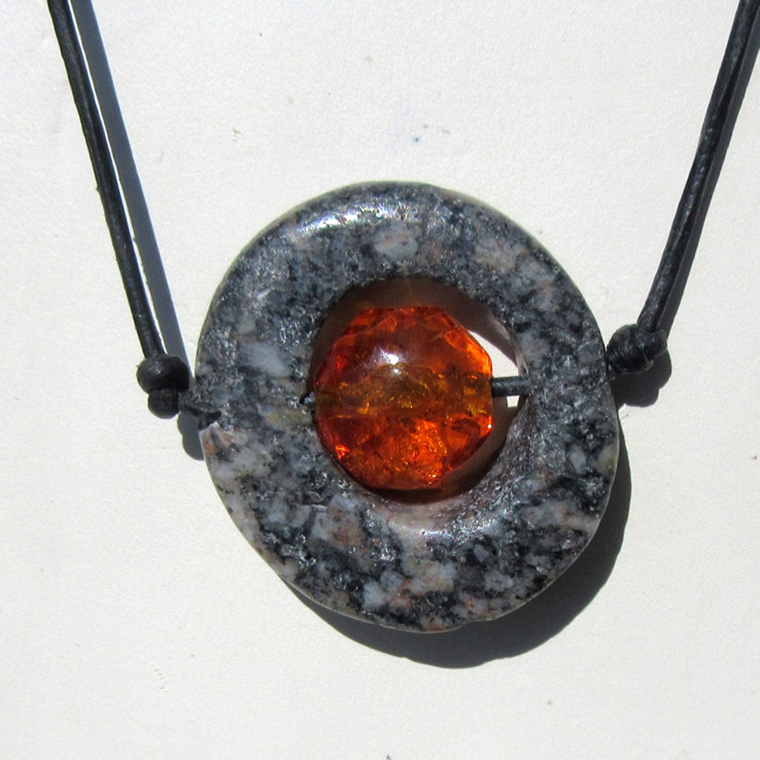 Bernsteinperle in gebohrter Steinscheibe, Unikat