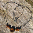 Collier aus Bernstein in dunklem Holzring – Einzelstück