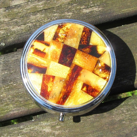 Runde Pillendose aus Edelstahl mit Bernsteinintarsien